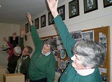 Trefoil Guild members doing yoga during a break from volunteering at the National Offices