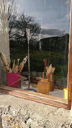paintbrushes in the window